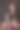 美丽的年轻女子坐在飘落的花瓣下图片下载