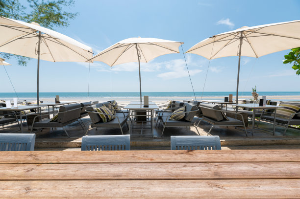 餐桌上的木质台面和沙滩上的雨伞图片下载