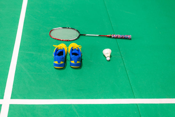 穿有羽毛球和球拍的羽毛球鞋。图片下载