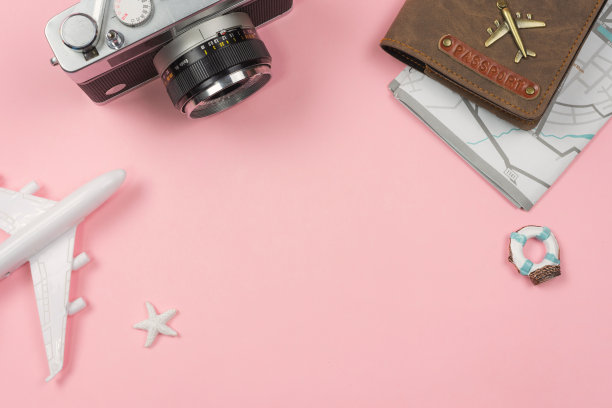 带有玩具飞机和护照背景粉的复古相机图片下载