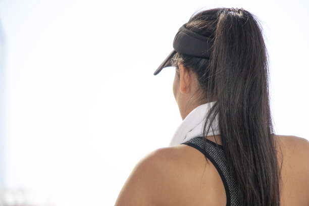 一位运动的亚洲妇女在城市里锻炼后正在休息图片下载