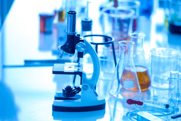 蓝色背景下的显微镜试管和烧杯图片下载