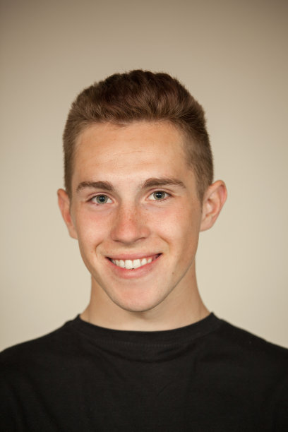 一个迷人的18岁男子的工作室肖像在米色背景黑色t恤图片下载