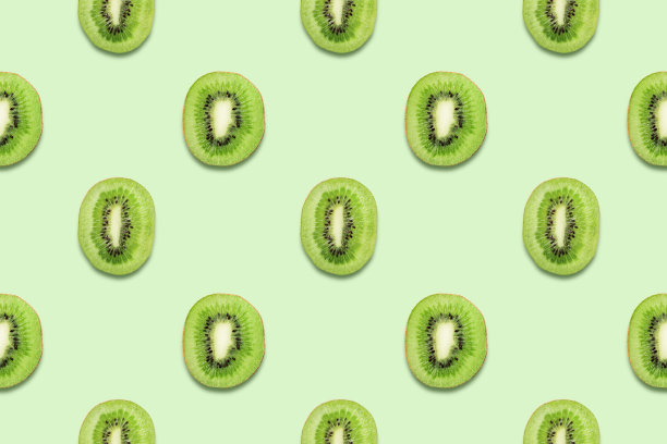 猕猴桃切片热带无缝模式在绿色背景最小的夏季概念。图片下载