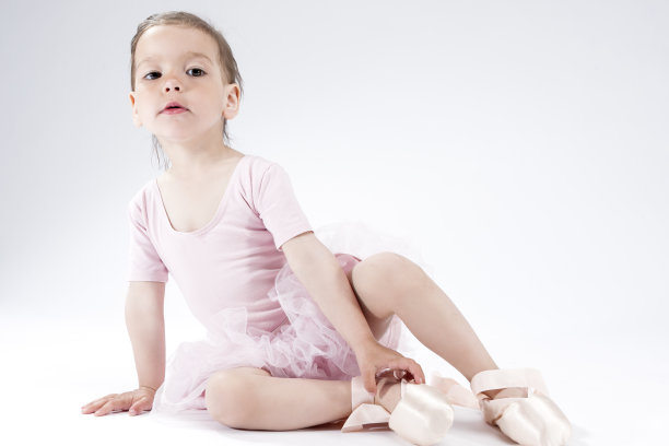 好奇和可爱的小女孩假装芭蕾舞演员在脚趾。在白色的背景下。水平图像组成图片下载