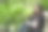 微笑的黑发女孩坐在公园的长椅上读一本软皮书。图片下载