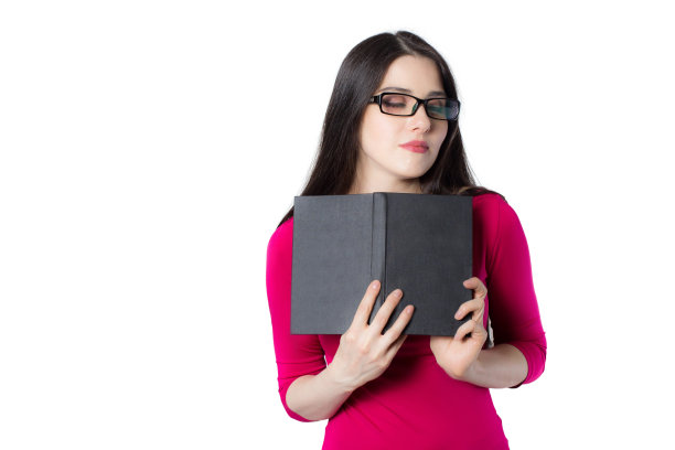 漂亮的年轻女子，戴着眼镜，拿着一本书。图片下载