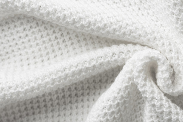针织物的背景。用白色纯有机棉纱编织成同心螺旋图案。时尚服装工艺概念。带有复制空间的模板图片下载