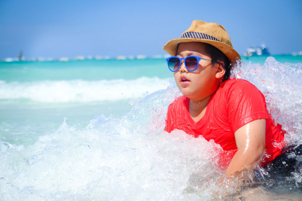 一个亚洲男孩在海里玩图片下载