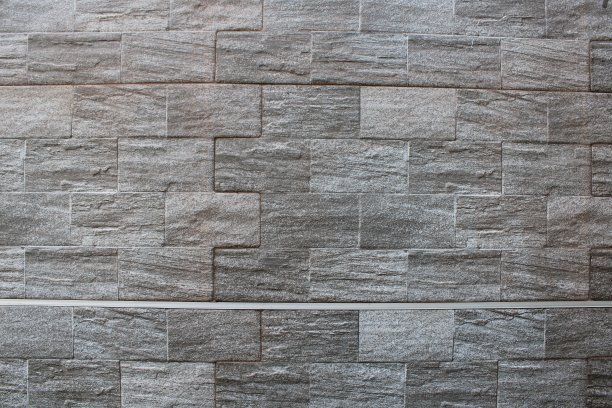 黑色的石墙作为背景设计。图片下载