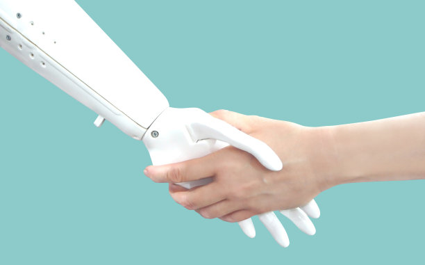 人的手和机器手。握手。网络沟通概念孤立在蓝绿色背景下。未来的技术。图片下载