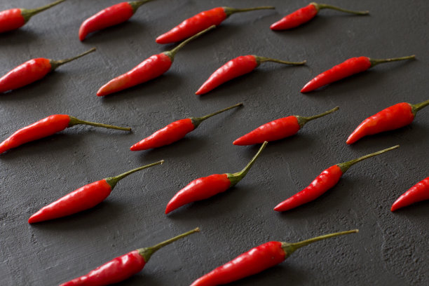 红辣椒在黑色的黑色背景在黑色的桌子上。很多红辣椒。为你的文本复制空间。平躺，俯视图。有节奏的影像，照片或物体的重复图片下载