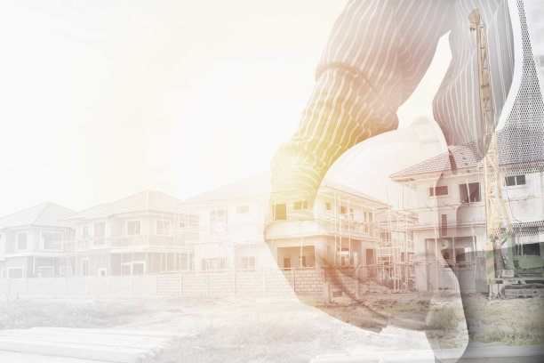 建筑工程师工人手持头盔，与在建的住宅新房进行双重暴露图片下载