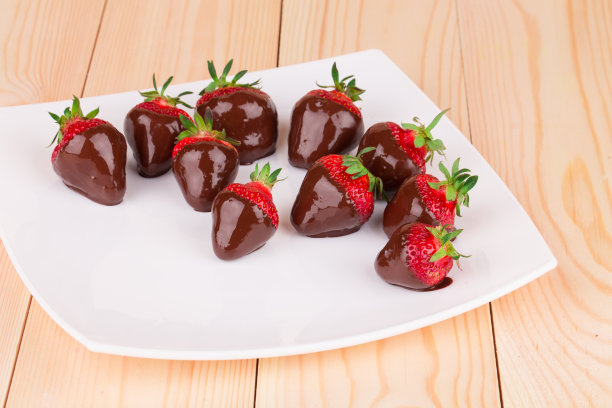 装在盘子里的巧克力草莓。图片下载