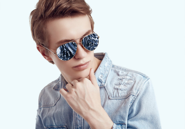 帅气的潮人戴着时尚太阳镜，穿着牛仔裤夹克图片下载