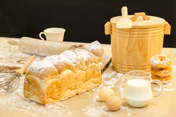 面包，鸡蛋，牛奶，甜甜圈和新鲜牛奶在木桌上的照片。早餐准备，日常用品。图片下载