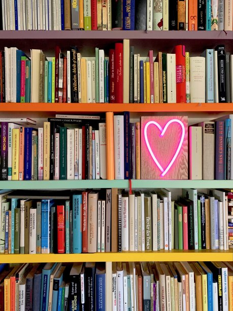 书架上摆满了书，还有一个心形的霓虹灯图片下载