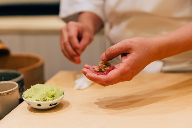 日本料理师制作中脂蓝鳍金枪鱼寿司，用手将新鲜的山葵糊得整整齐齐。日本传统和奢侈的膳食。图片下载