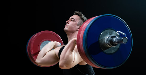 年轻男子举着杠铃图片下载