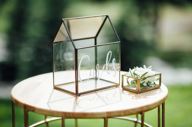 表装饰婚礼。桌上的花瓶、玻璃杯和礼品盒里放着一束美丽的鲜花。图片下载