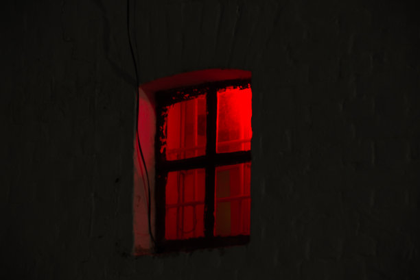 夜晚的窗户亮着明亮的红光图片下载