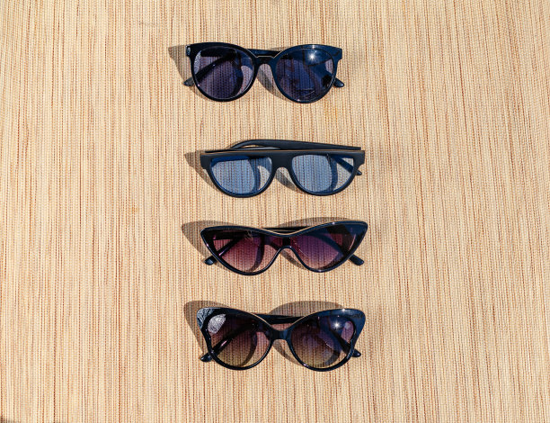 不同的太阳镜在太阳下的稻草背。夏日场景，光学，护眼图片下载