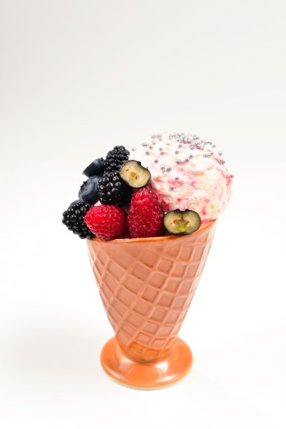 白色背景上有蓝莓、黑莓和覆盆子的冰淇淋。副本的空间。图片下载