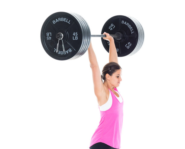 强壮的女运动员举起沉重的杠铃图片下载