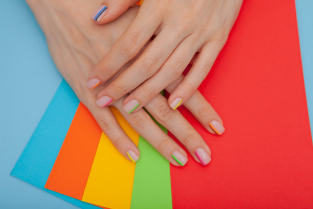 现代时尚的美甲彩虹或夏日心情，在蓝色的桌子上用彩色信封图片下载