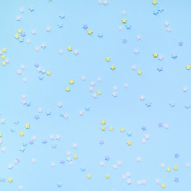 蓝色背景上的小星星和五彩纸屑图片下载