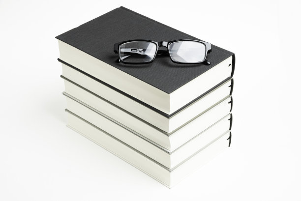 一套整齐堆放的五本书和老花镜图片下载