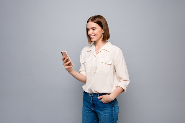 特写照片惊人的美丽她她的女士手手臂电话奇怪的样子屏幕读者电子邮件信件社交媒体粉丝穿着休闲牛仔裤牛仔白衬衫孤立的灰色背景图片下载
