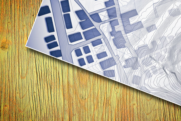 想象地籍地图的领土与建筑物和地形图上的木桌-概念图像图片下载