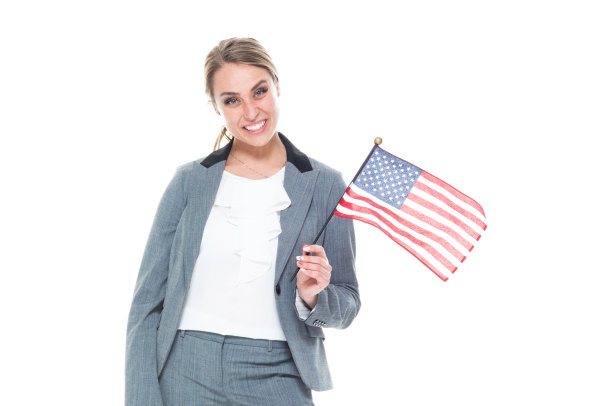 美丽的女商人举着一面小美国国旗图片下载