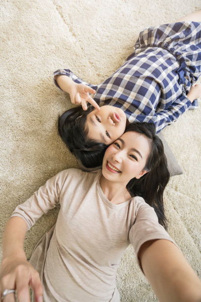 母女俩在客厅的家庭背景中自拍。图片下载