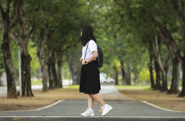 女少年大学生的肖像树之间的校服图片下载