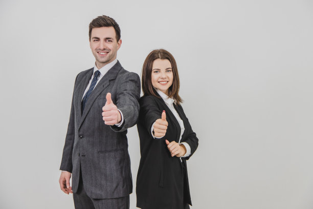 商人和商人背靠背站着，竖起大拇指，微笑着。图片下载
