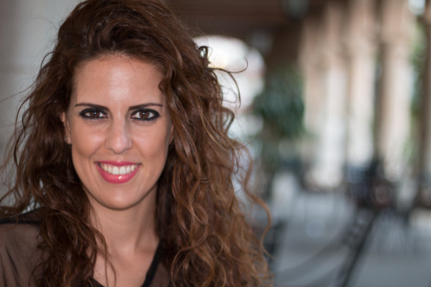 一个年轻的黑发女人在阳台上的特写。图片下载