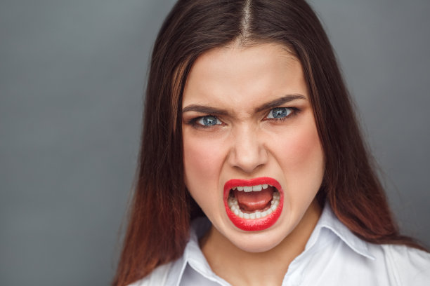 自由泳。女人孤立地站在灰色愤怒地喊叫近距离图片下载