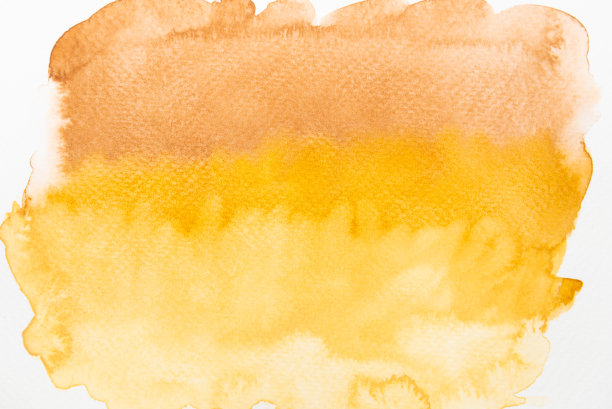 抽象的棕色，黄色和橙色水彩在纸上。图片下载