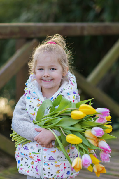 一个金发女孩的肖像，手里拿着一束郁金香图片下载