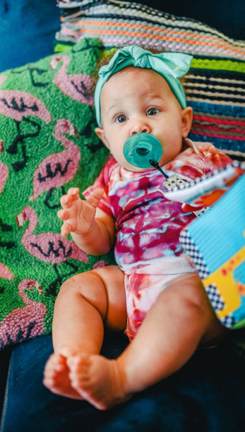 可爱的6个月大的混血宝宝和卷头发在室内拍摄的肖像图片下载