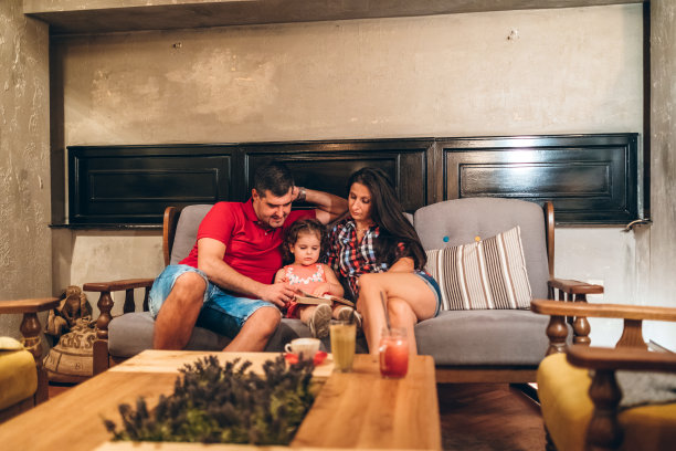 爸爸妈妈和可爱的小女儿一起看书图片下载