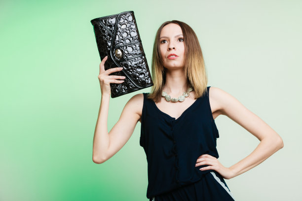 时尚的女人时尚女孩拿着黑色的手提包图片下载