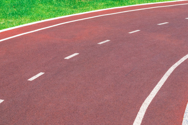 红色的合成脚踏车或自行车道，带有白色标记，向右转。图片下载