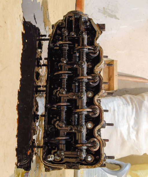缸体的头部。把缸体的头部从发动机上拆下来修理。发动机机油中的零件。在汽车发动机维修服务中图片下载