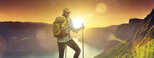 一个背着背包在挪威峡湾徒步旅行的女人图片下载