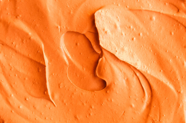 橙色面膜(南瓜霜，身体磨砂膏)纹理近距离。抽象的背景与画笔笔触。图片下载