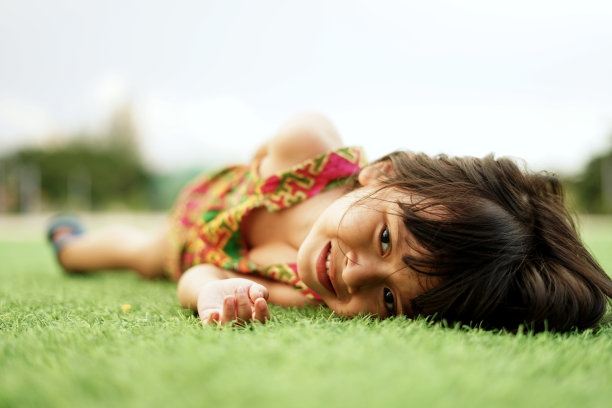乖戾的小女孩躺在草地上图片下载