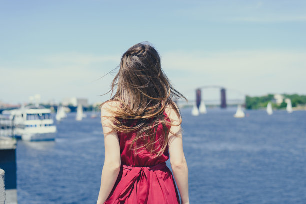 天晴碧水自然欢乐逃离情感表达度假美发世界邮轮概念。背影后面看肖像照片的漂亮快乐兴奋的女孩欣喜地看着海云图片下载